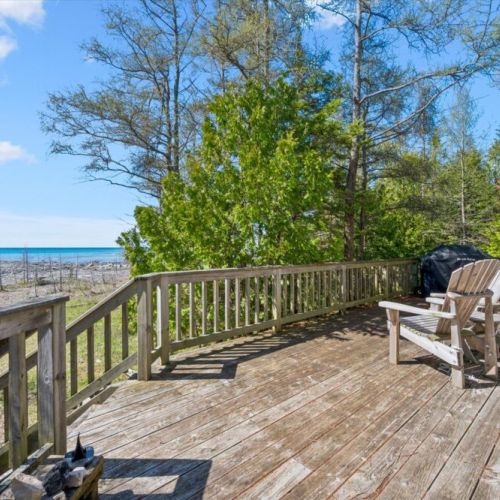 Step outside onto the expansive deck and take in the fresh lake breeze, with plenty of space to unwind and enjoy the natural setting.