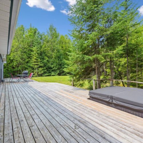 Unwind on the expansive back deck, complete with plenty of seating and the private hot tub.