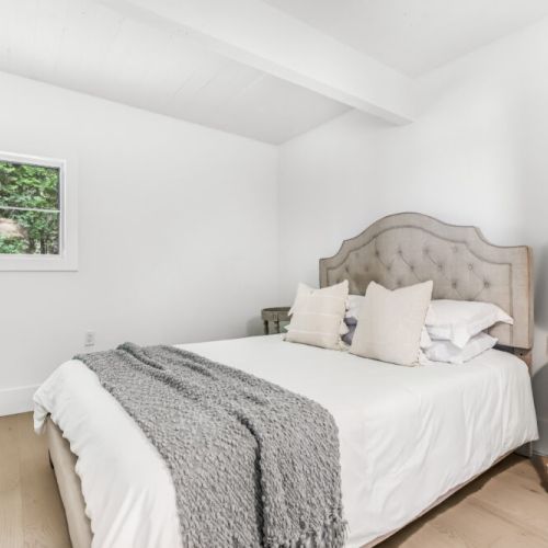 Simple peaceful sleeping space with fresh bedding and lots of natural light.