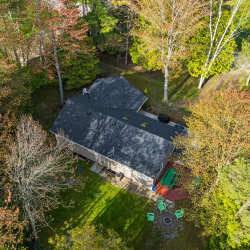 Enjoy a bird's-eye view of the property, complete with a fire pit, hot tub, and plenty of space to relax outdoors.