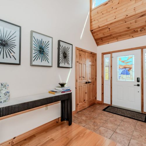 Stylish foyer with stained glass door and modern art—sets the tone for your relaxing vacation.