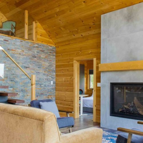 Warm rustic elegance—stone fireplace and natural wood finishes throughout.