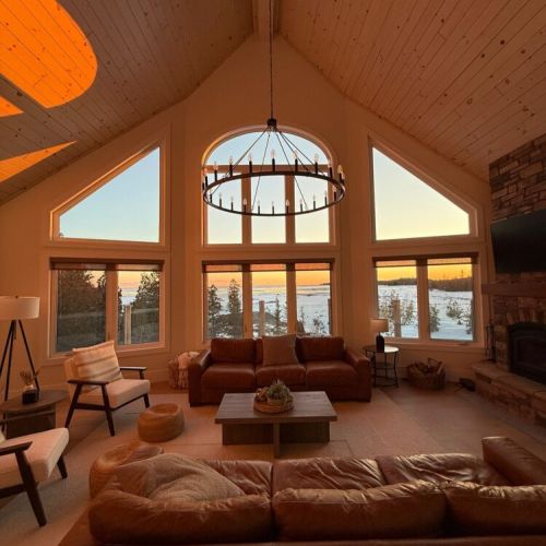 Vaulted pine ceilings and soaring windows frame breathtaking lake views, filling the Great Room with natural light from sunrise to sunset.