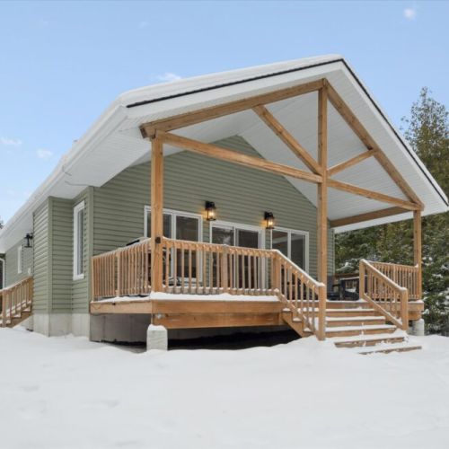 Classic post-and-beam exterior with a welcoming front deck—an inviting space to gather in any season.