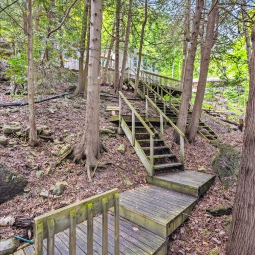 Wind your way through towering trees and serene woodland paths. This private stair network connects the cabin’s upper and lower levels, creating a true “treehouse” experience.