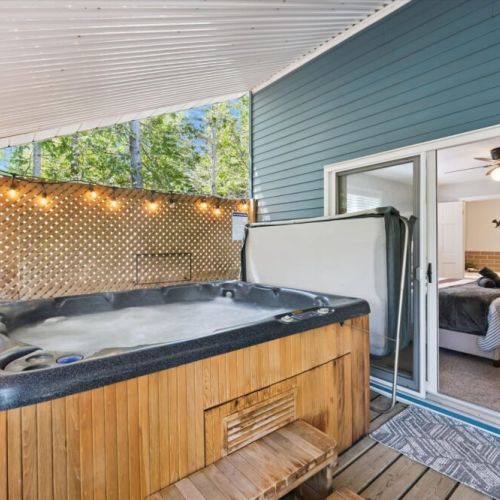Unwind in the outdoor hot tub after a day on the lake, surrounded by peaceful woodland views.