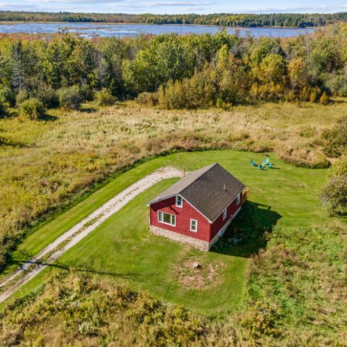 A bird’s-eye view of Smith Homestead, surrounded by rolling countryside, forest and the natural beauty of the Bruce Peninsula.