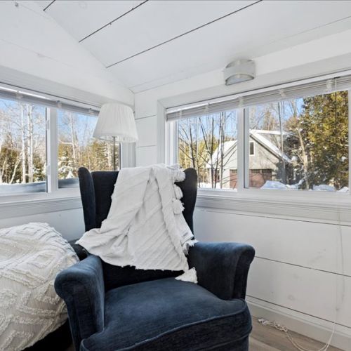 A cozy reading nook with forest views and natural light pouring in. The ideal spot for morning coffee, journaling, or curling up with a book.
