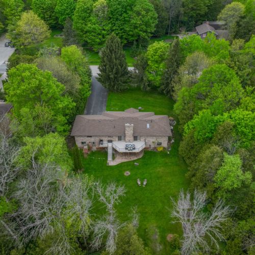 Bird’s eye look at the home and expansive backyard, showcasing the wide-open space, surrounding forest, and peaceful privacy.