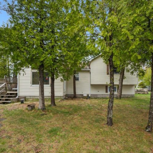 Mature trees provide shade, privacy, and a tranquil cottage atmosphere throughout the property.
