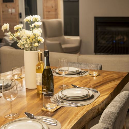 Gather around the dining table and enjoy a delicious meal in this cozy and inviting space. The warm glow of the fireplace and the soft ambient lighting create the perfect atmosphere for relaxation and conversation.