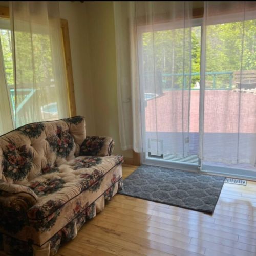 Quiet indoor seating with forest light filtering in. A peaceful space to sip your morning coffee or escape into a book.