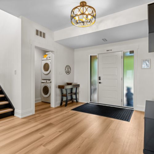 The bright, open foyer welcomes you with convenient laundry access and plenty of room to come and go comfortably.