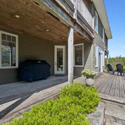 Covered lower patio area ideal for relaxing in shade and comfort.