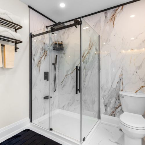 The spacious walk-in shower features modern finishes and premium toiletries for your comfort.