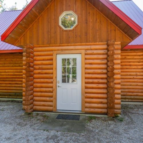 Private and deceptively large. A closer view highs the octagonal window and the warm, inviting entryway, setting the stage for the rustic experience inside.