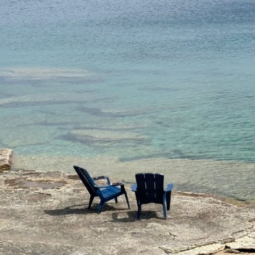 Adirondack chairs right on the water’s edge for relaxing, reading, or sunset watching.