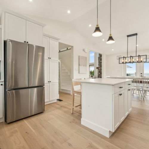 Entertain in a bright, fully stocked kitchen with high ceilings, modern fixtures, and large island seating—perfect for group meals.