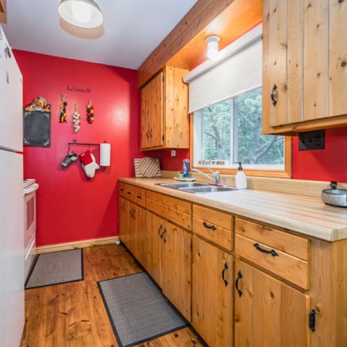 The cozy galley kitchen is tucked away beside the dining space.