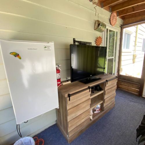 Indoor comfort meets outdoor vibes in the screened patio lounge with TV and mini fridge. Entertainment and snacks on hand!