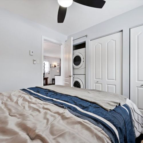 Thoughtfully laid-out bedroom with in-suite laundry access for added convenience during longer stays.