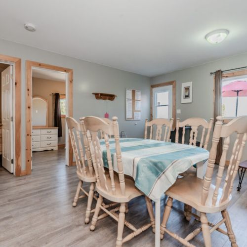The large dining area is adjacent to the kitchen, offering a welcoming spot to gather for meals or game nights.