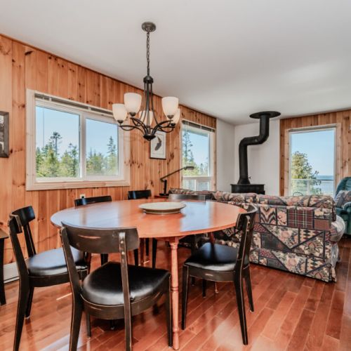 Sunny dining area with beautiful lake views — ideal for family meals, game nights, and gathering after a day of exploring.
