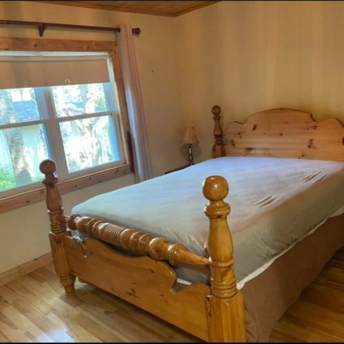 Sleep peacefully in a wood-furnished room with forest views—ideal for nature lovers seeking a serene Bruce Peninsula stay.