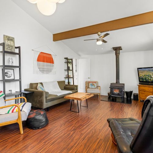 Relax in the inviting living room with a cozy wood stove—the perfect place to unwind after a day of adventure.