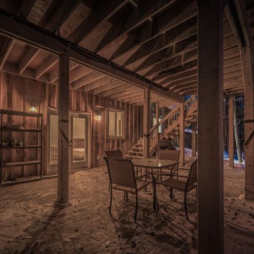 Covered outdoor space with seating—ideal for morning coffee, fresh-air dinners, or winding down in the evening. Even in winter, the forest views are stunning.