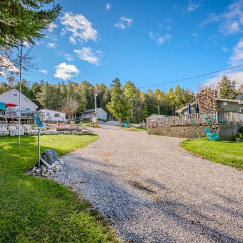 A scenic view of the cabin area, surrounded by lush trees and ample open space, perfect for a relaxing getaway in nature.
