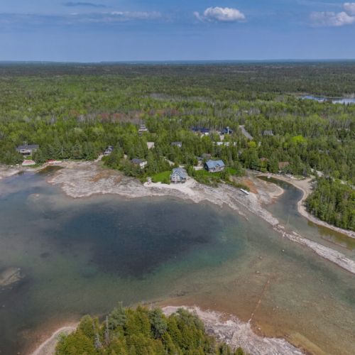 An expansive view of the surrounding area, highlighting the natural beauty and tranquility of Purgatory Cove. The cottage’s prime location offers both privacy and scenic views.