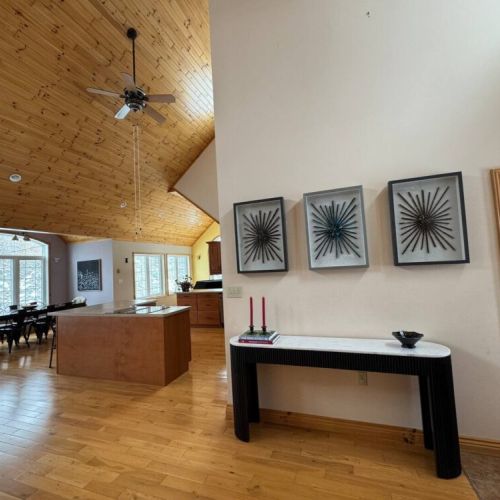 Artfully styled hallway flows into a bright and airy kitchen space—bringing together modern touches and cottage charm.
