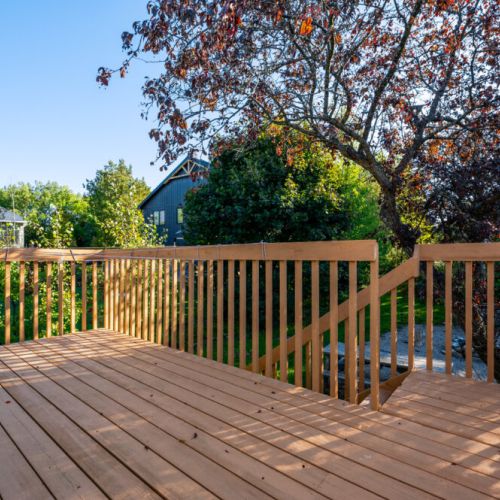 The spacious deck provides a peaceful outdoor seating area, ideal for enjoying morning coffee or evening relaxation.