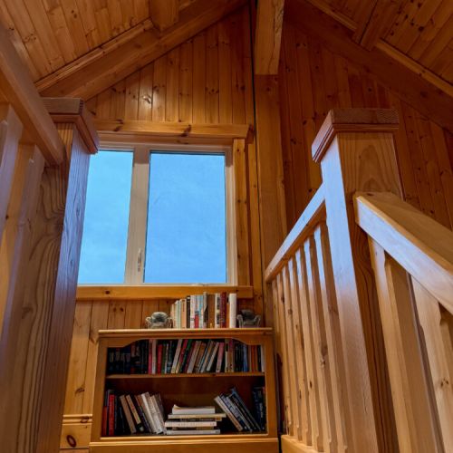 Cozy up with a good book in this charming nook —perfect for relaxing, reading, and enjoying peaceful cottage retreats.