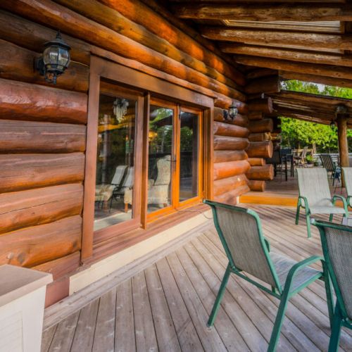 A seamless transition between indoor and outdoor living, this deck extends from the cabin with ample seating, perfect for enjoying fresh air and stunning surroundings.