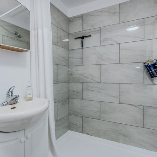 Freshen up in a bright, modern bathroom with a spacious walk-in shower—perfect for unwinding after a day of adventure, hiking, or exploring.