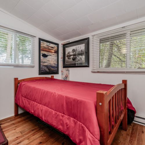 Wake up refreshed in a cozy single room with big windows, lakeside artwork, and natural light—ideal for solo travelers or little ones.