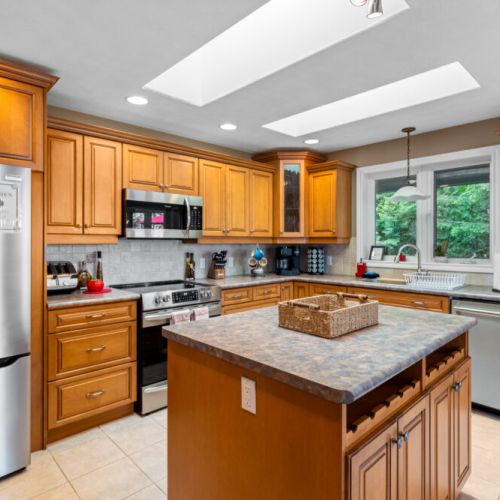 The fully equipped kitchen features generous counter space, a large island, and plenty of cabinetry for preparing meals during your stay.