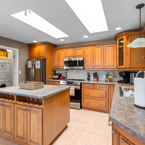 Skylights fill the spacious kitchen with natural light, creating a bright and inviting space for cooking and gathering.