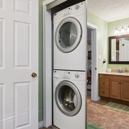 Convenient in-cottage laundry with stacked washer and dryer for longer stays.
