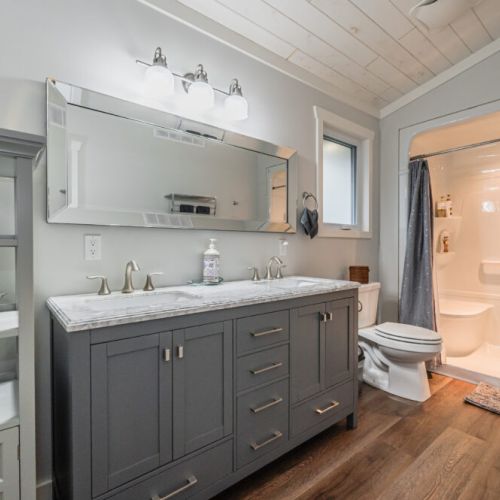 Modern bathroom with double vanity and walk-in shower for added comfort and convenience.