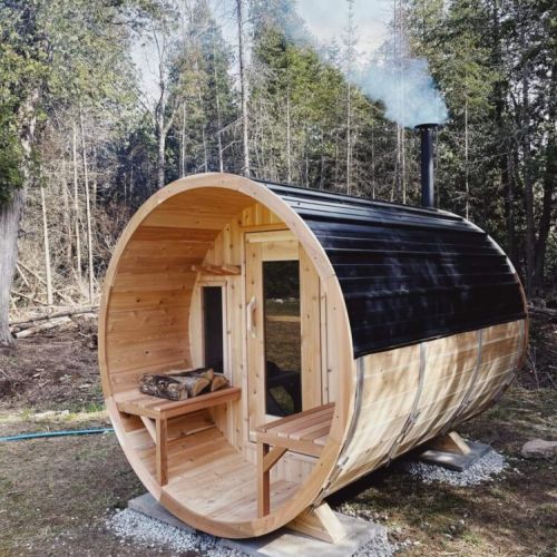 The newly minted Cedar Barrel Sauna was handcrafted onsite. It features an airtight wood burning stove which lights from the back of the sauna.