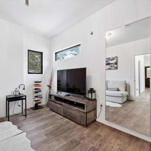 A minimalist media space offers a quiet place to unwind with a movie or enjoy a peaceful moment indoors.