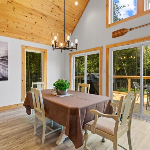 Enjoy family meals with easy access to the wraparound deck for indoor-outdoor living.