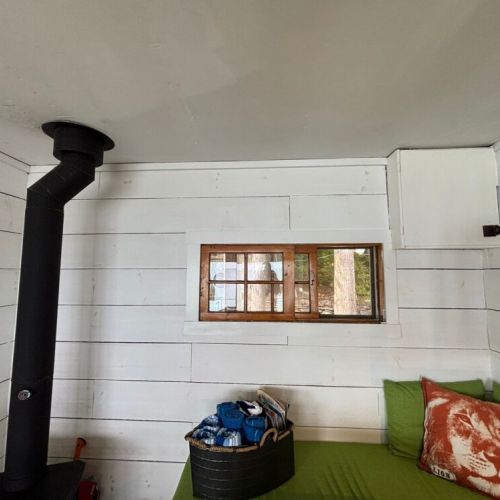 Bench seating beside the wood-burning stove for warmth and relaxation.