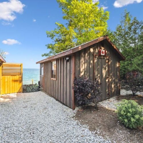 A cozy cedar outbuilding adds extra character and functionality—perfect for storage or simply enjoying the rustic design.