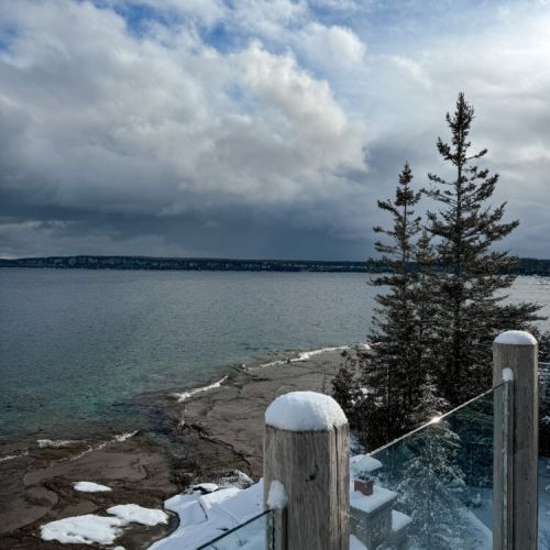 Winter magic meets waterfront charm! Stay cozy while taking in panoramic lake views from this beautiful, snowy vacation rental destination.