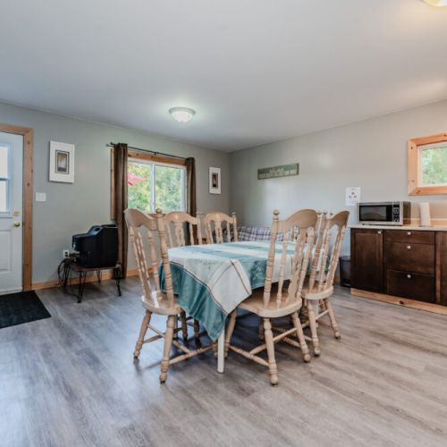 Inside, the open dining area features a large table that seats eight, ideal for group meals and bonding time.