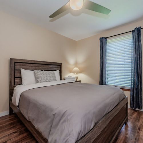 The master bedroom offers a restful escape with a comfortable queen-sized bed and stylish furnishings for a great night’s sleep.